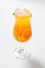 Drink with lemon, orange and ice on white background