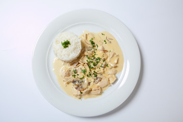 stewed chicken with white rice and mashroom sauce