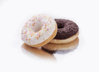two donuts with chocolate and icing on a white background
