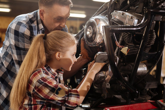 Productive passionate kid happy to help her dad