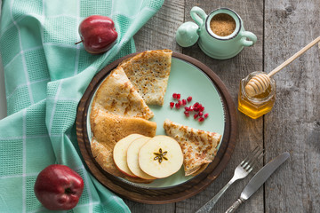 Tasty traditional russian breakfast of pancakes with honey on plate. Rustic style.