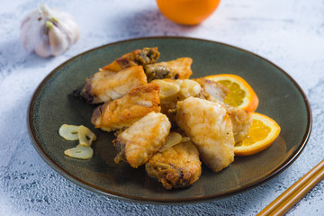 fried fish fillets flavored with garlic and orange