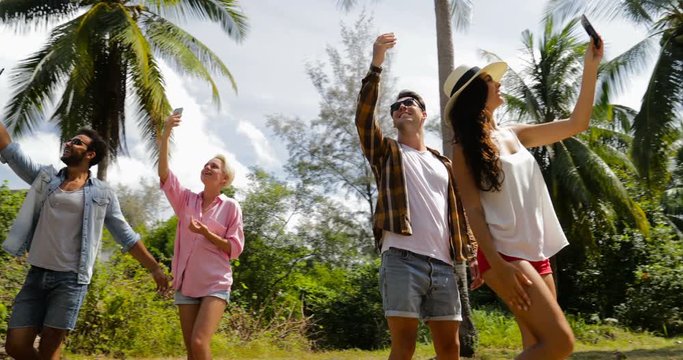People Group Talking Use Cell Smart Phones Take Photos Outdoors Under Palm Trees, Smiling Mix Race Man And Woman Friends Slow Motion 60