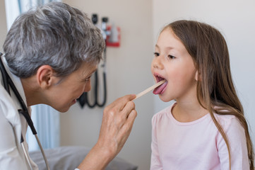 Doctor examining child mouth