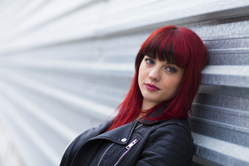 Fototapeta premium Portrait of a young woman, model of fashion in urban background