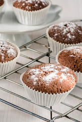 Chocolate muffins on a white wooden table