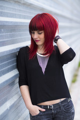 Portrait of a young woman, model of fashion in urban background