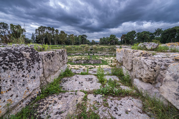 Ruins of amphitheater from Roman period in Neapolis Archaeological Park in Syracuse, Sicily Island of Italy