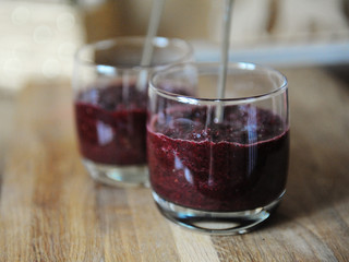 Smoothies in a glass, close-up. Wooden texture