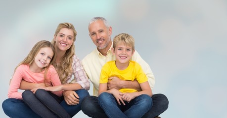 Happy family sitting over blur background