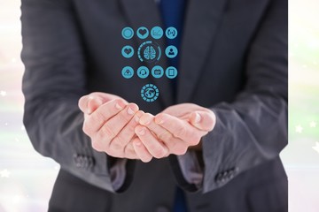 Digital composite image of businessman protecting medical icons