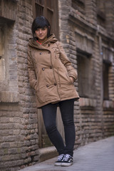 Fototapeta na wymiar Young modern looking woman staring at camera, with a coat.
