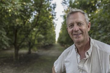 Portrait of smiling Caucasian man in orchard