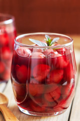 Sour cherry compote dessert served with mint leaves