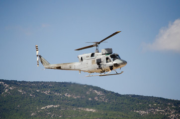 Helicopter bell uh 1.Exhaust gases,mountain hill background
