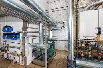Interior of industrial, gas boiler house with a lot of boilers and equipment