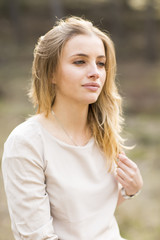 Portrait of blond woman in white dress outdoor