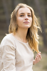 Naklejka premium Portrait of blond woman in white dress outdoor