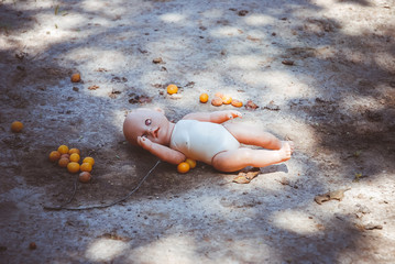Abandoned doll lies on the ground