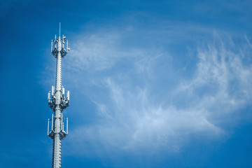 High radio tower with blue sky in the background.