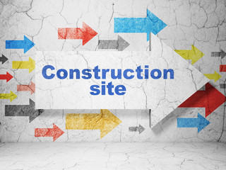 Constructing concept: arrow with Construction Site on grunge wall background