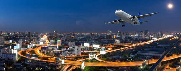 Naklejka premium Airplane take off over the panorama city at night