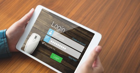 Hands holding tablet PC with log in page on screen