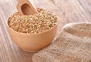 Buckwheat isolated in wooden bowl on table