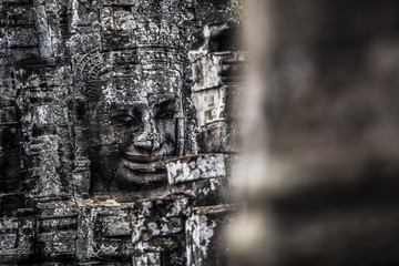 Fototapeta na wymiar Stone faces at Bayon Temple in Angkor Wat