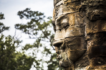Fototapeta na wymiar Stone faces at Bayon Temple in Angkor Wat