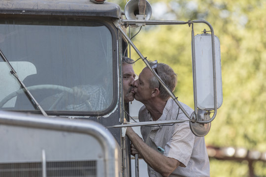 Caucasian man kissing truck driver