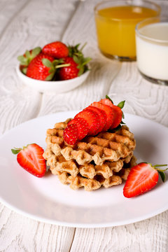 Waffels with strawberry on a white plate