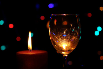 Burning sparklers in a wine glasses cup