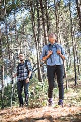 Young couple hiking at the pine forest.