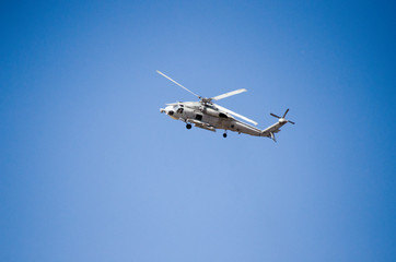 Black hawk helicopter rescue team.Fly maneuvering, nose up blue sky background