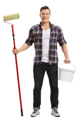 Young man holding a paint roller and a color bucket