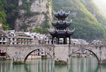 Ancient Pagoda at bridge in Zhenyuan Ancient Town on Wuyang river in Guizhou Province, China