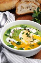 Pea puree soup with poached egg  and peppermint