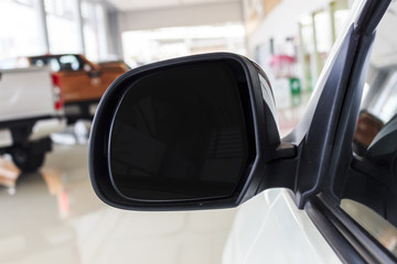 car side mirror window with soft-focus in the background. over light
