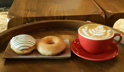 Delicious doughnuts and a cup of cappuccino.