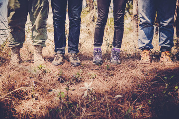 Close-up of legs of  hikers standing on the forset.