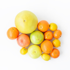 Fruit background. Fresh citrus fruits on white background. Flat lay, top view.