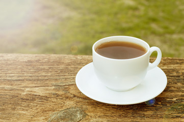 cup of tea with lemon on wooden background