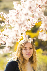 Fototapeta premium Image of pretty businesswoman looking at camera on natural space