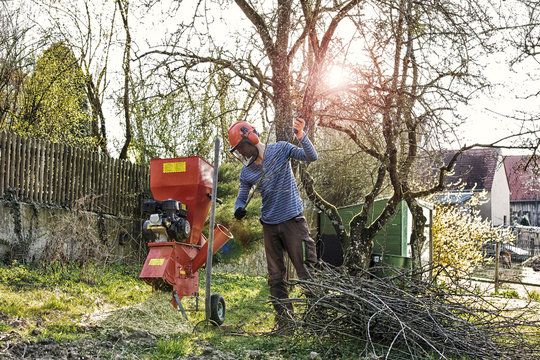 Young man chaffing wood
