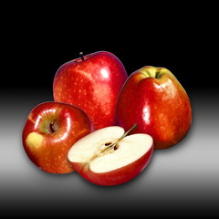 Red apple and slice isolated against  a black background.