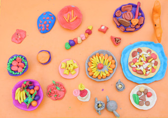 Children dazzled from plasticine dishes and food