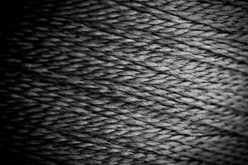 reel black synthetic thread. textile concept. abstract background