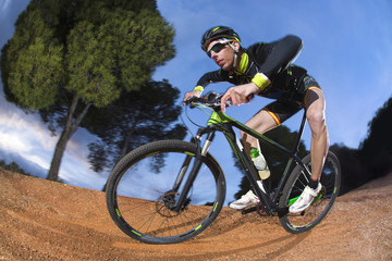 Cyclist man riding mountain bike on mountain.