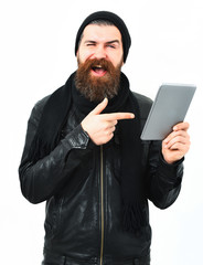 Bearded brutal caucasian hipster holding tablet